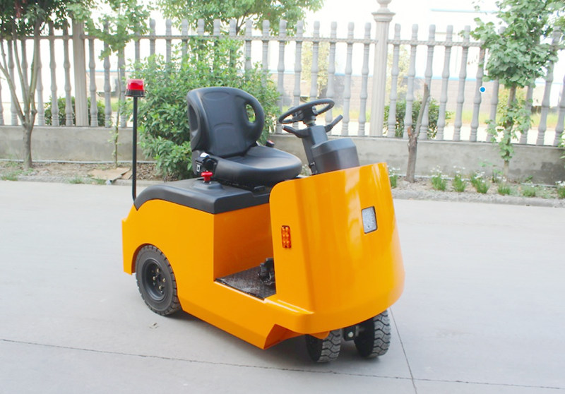 Seated rider electric tow tractor